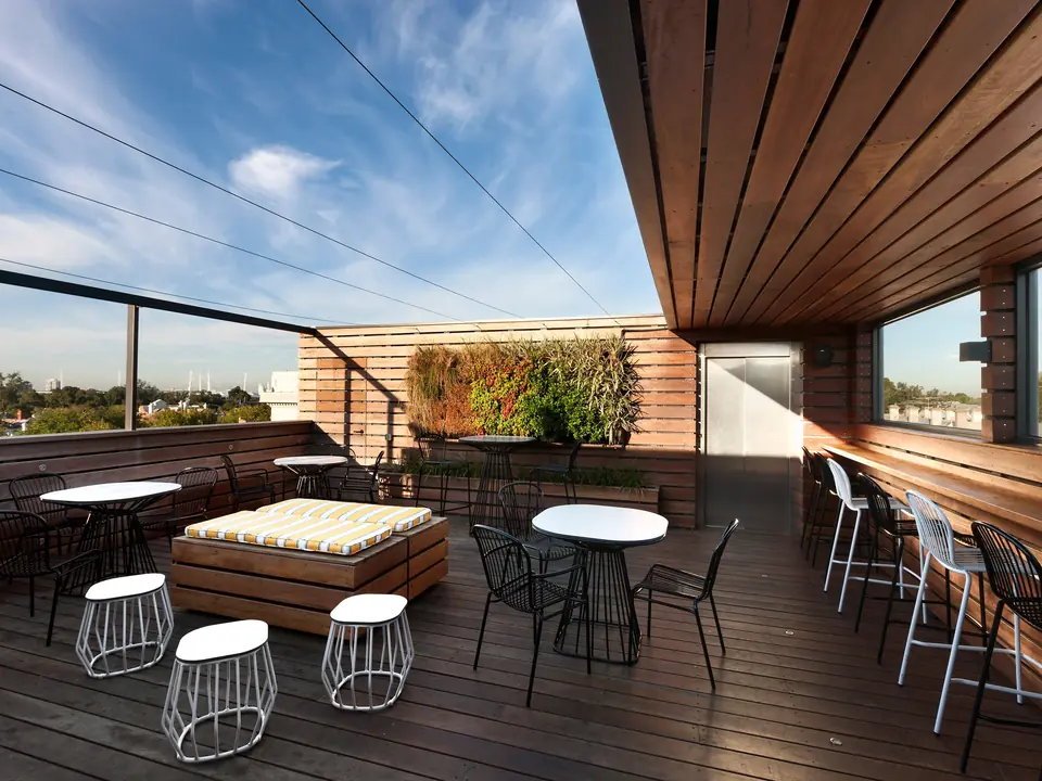 The Coppersmith Hotel rooftop bar with the Melbourne CBD skyline behind